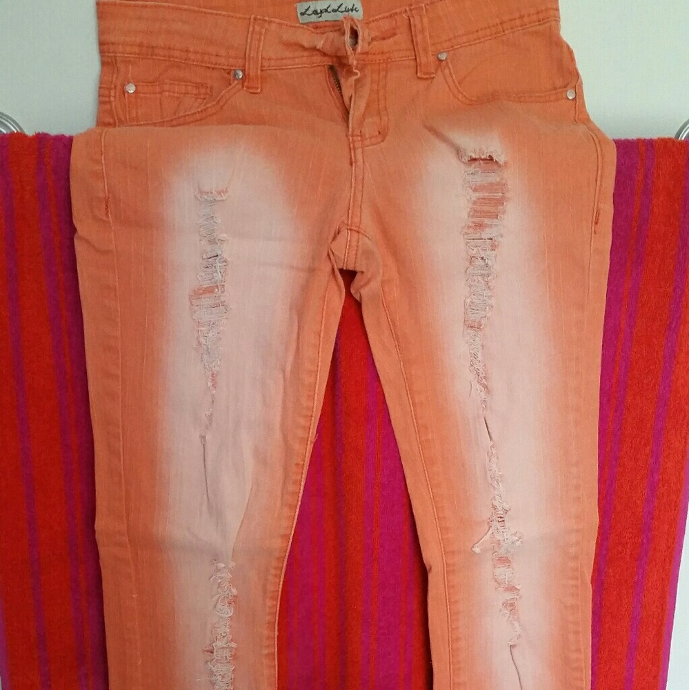 Bright orange distressed skinny jeans